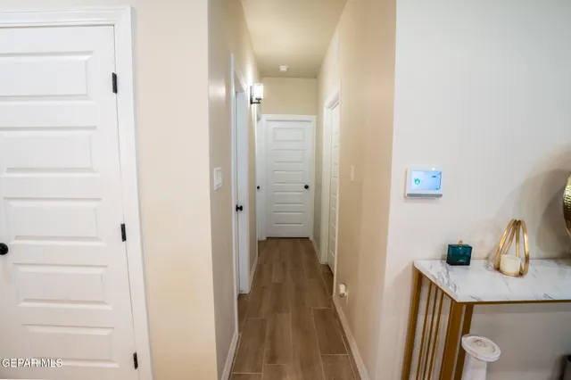 a view of a hallway with wooden floor and closet