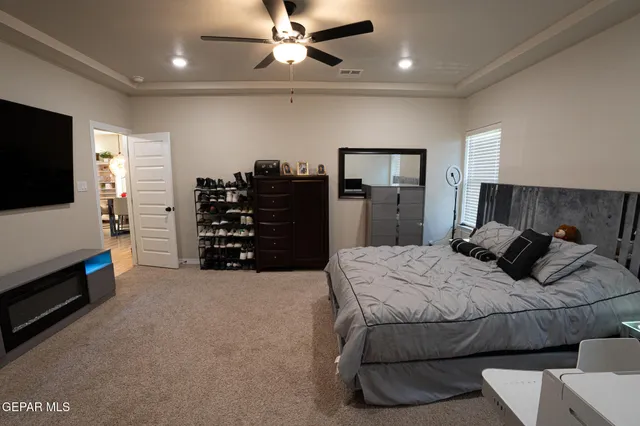 a bedroom with a bed and a flat tv screen