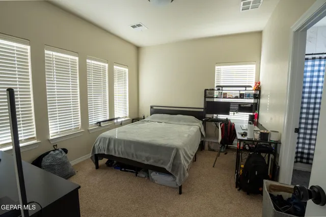 a bed room with a bed and a window