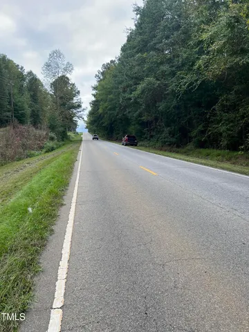 a view of a road with a trees in the background