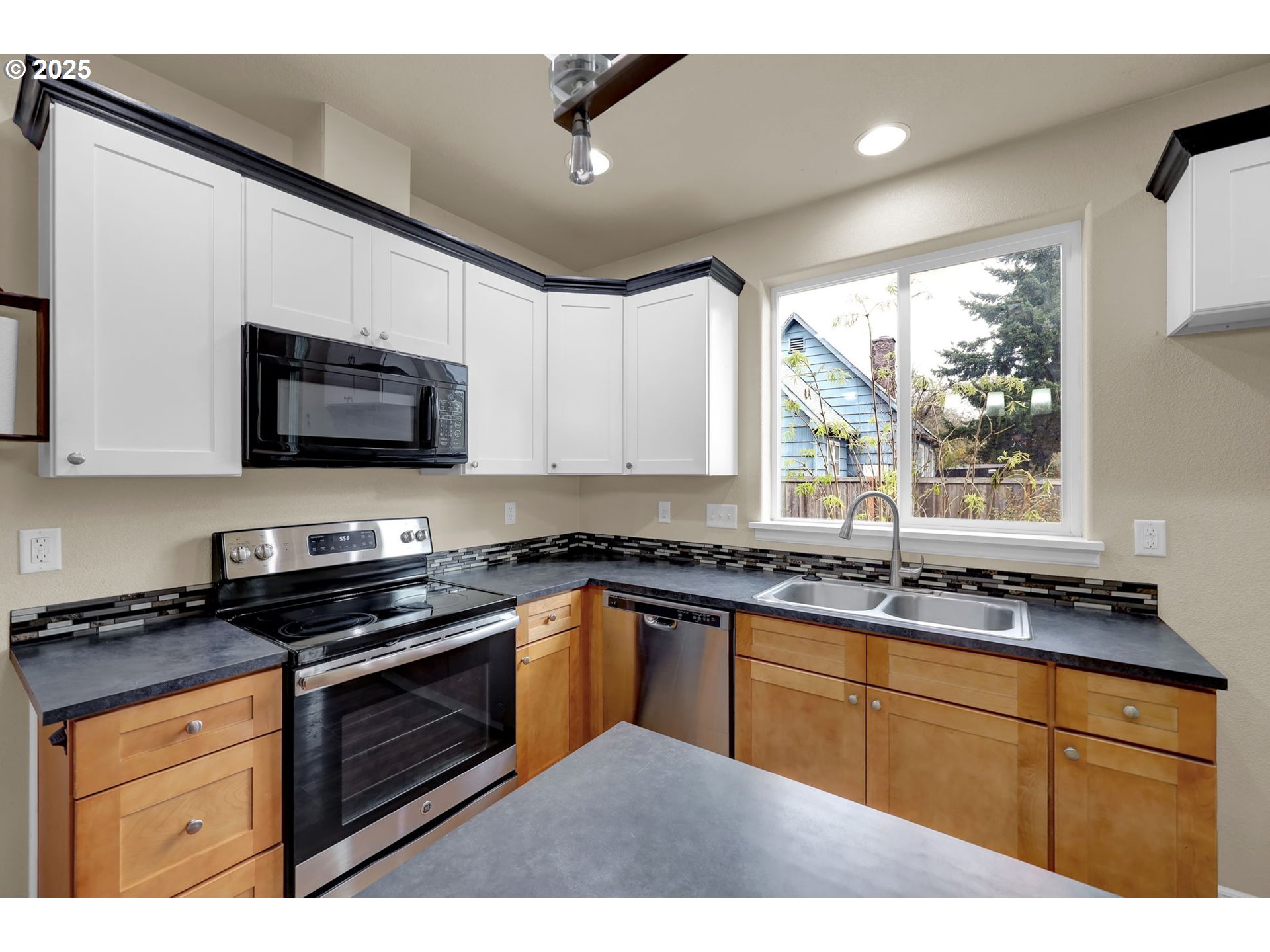 1725 Allea Drive Eugene, OR 97404 - Photo 17 of 44 a kitchen with stainless steel appliances granite countertop white cabinets granite counter tops and a window
