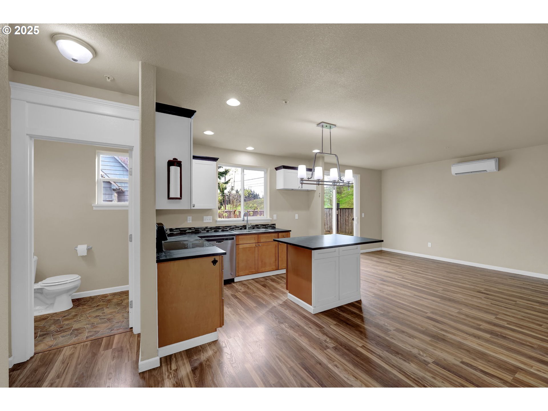1725 Allea Drive Eugene, OR 97404 - Photo 20 of 44 a open kitchen with a sink dishwasher a kitchen island a stove with wooden floor