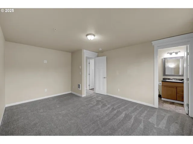 a view of an empty room with a kitchen