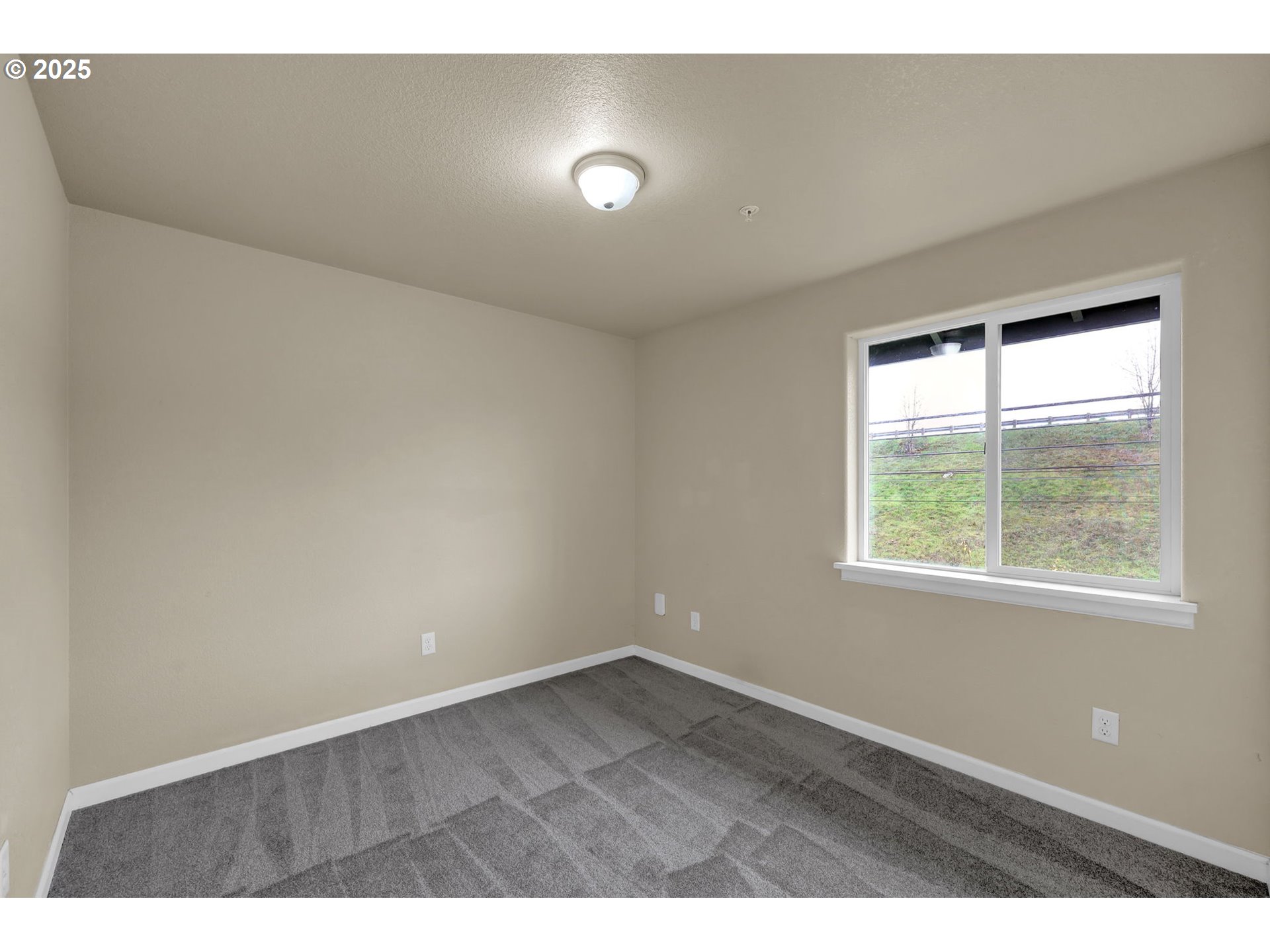 1725 Allea Drive Eugene, OR 97404 - Photo 29 of 44 an empty room with wooden floor and windows