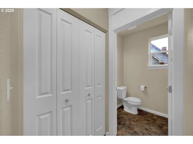 a bathroom with a toilet a sink and a mirror