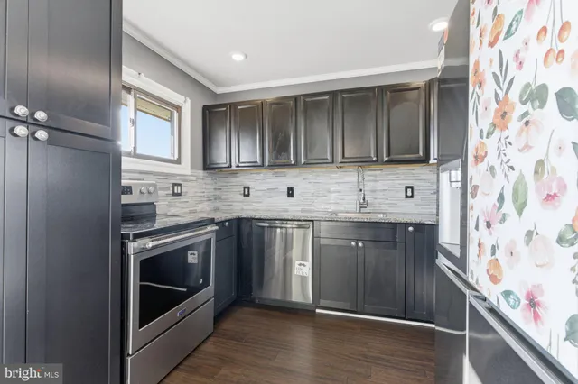 a kitchen with stainless steel appliances granite countertop a stove and a sink