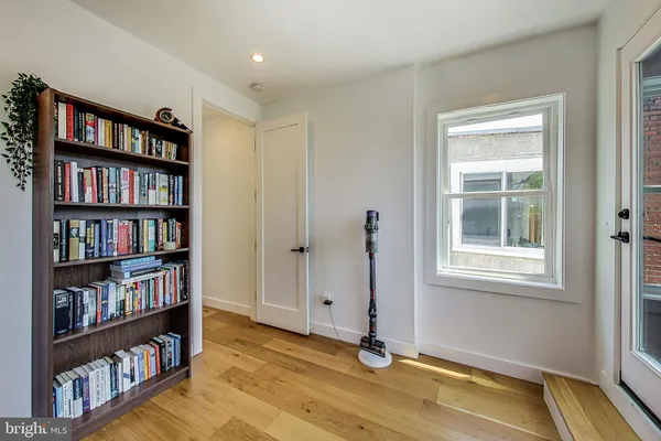 a view of room with window and book shelf