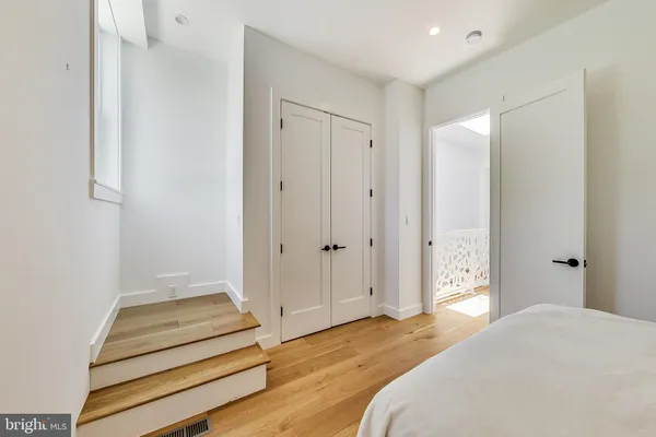 a bedroom with a bed and a view of bedroom