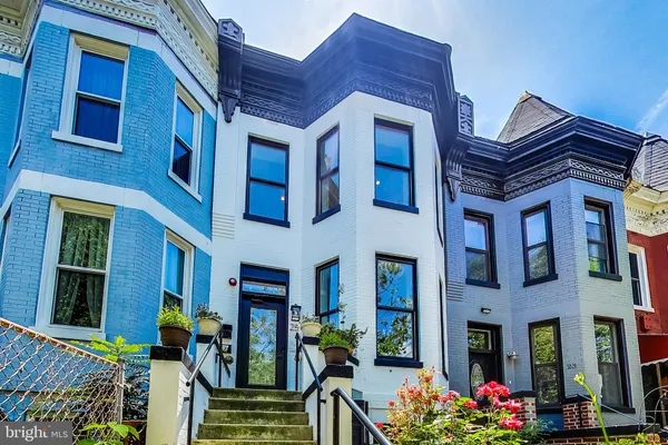 a front view of residential houses with an outdoor space