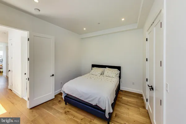 a room with a bed and wooden floor