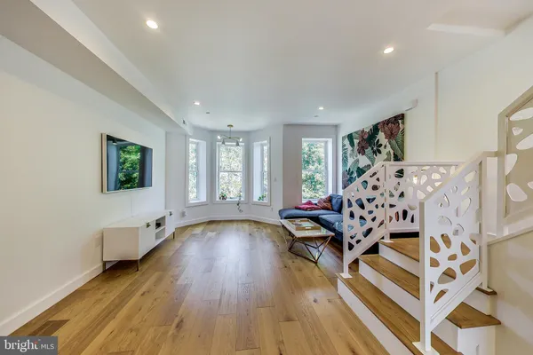 a living room with furniture and wooden floor