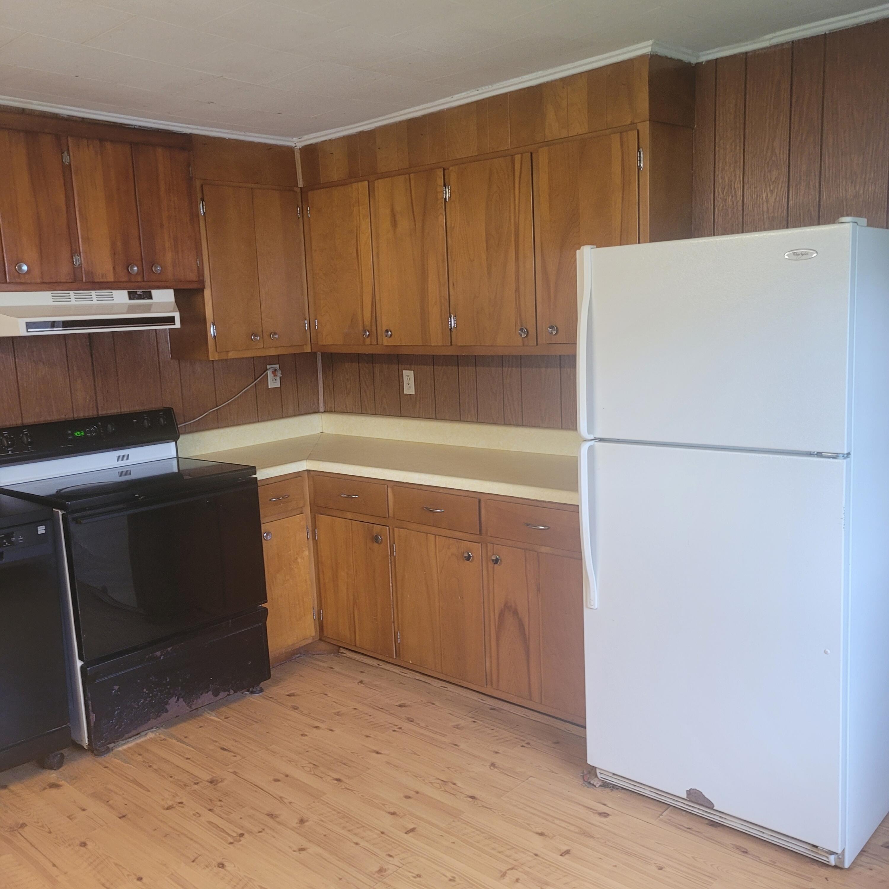 876 Dillon Street Pulaski, VA 24301 - Photo 6 of 18 a kitchen with a refrigerator and a stove top oven