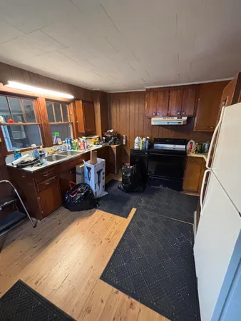 a room with furniture pool table and chairs