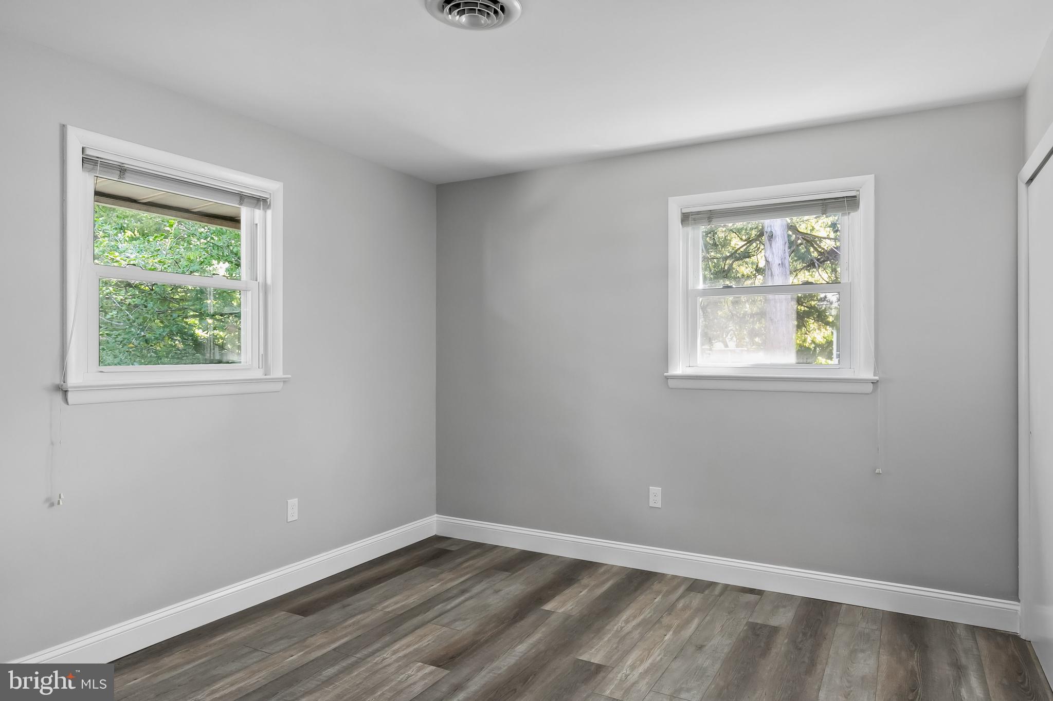 405 Hamilton Road Glassboro, NJ 08028 - Photo 16 of 28 a view of an empty room with wooden floor and a window