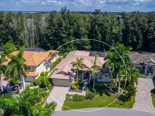 an aerial view of residential houses with outdoor space and ocean view
