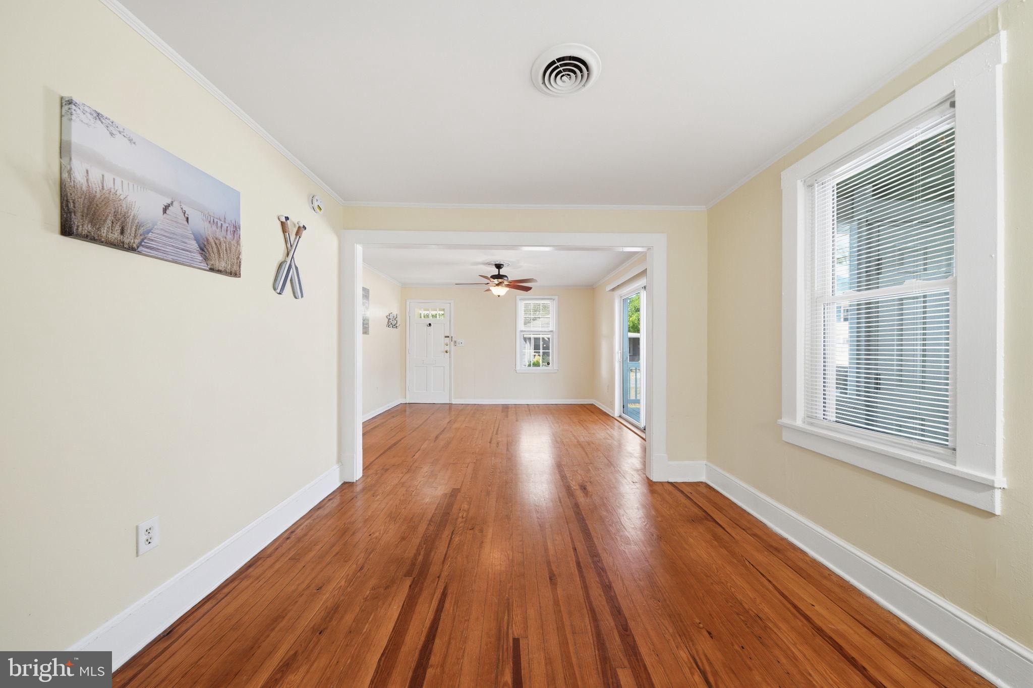 312 Vernon Street Colonial Beach, VA 22443 - Photo 15 of 45 a view of an empty room with wooden floor and a window