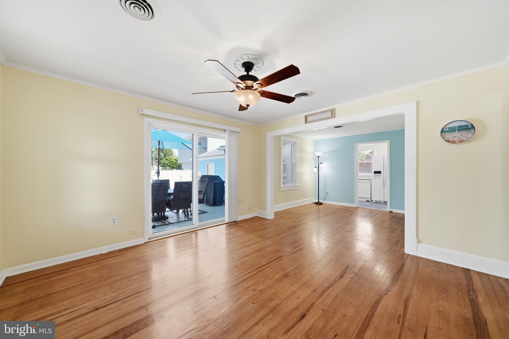 312 Vernon Street Colonial Beach, VA 22443 - Photo 16 of 45 a view of an empty room with window and wooden floor