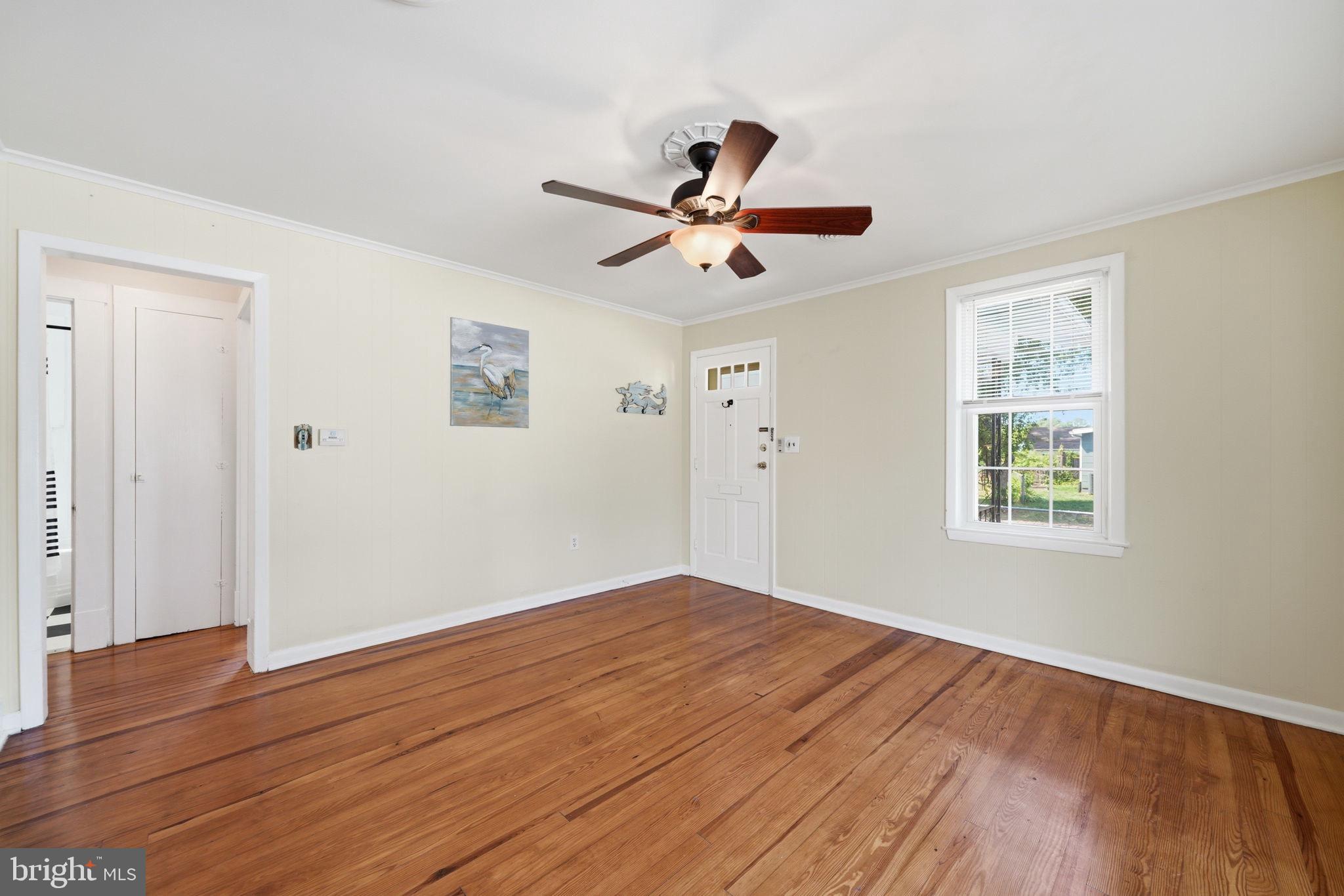 312 Vernon Street Colonial Beach, VA 22443 - Photo 18 of 45 a view of empty room with wooden floor and fan