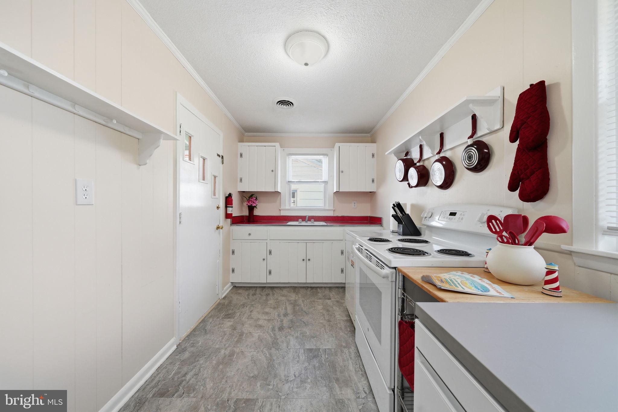 312 Vernon Street Colonial Beach, VA 22443 - Photo 19 of 45 a kitchen with a sink stove and cabinets