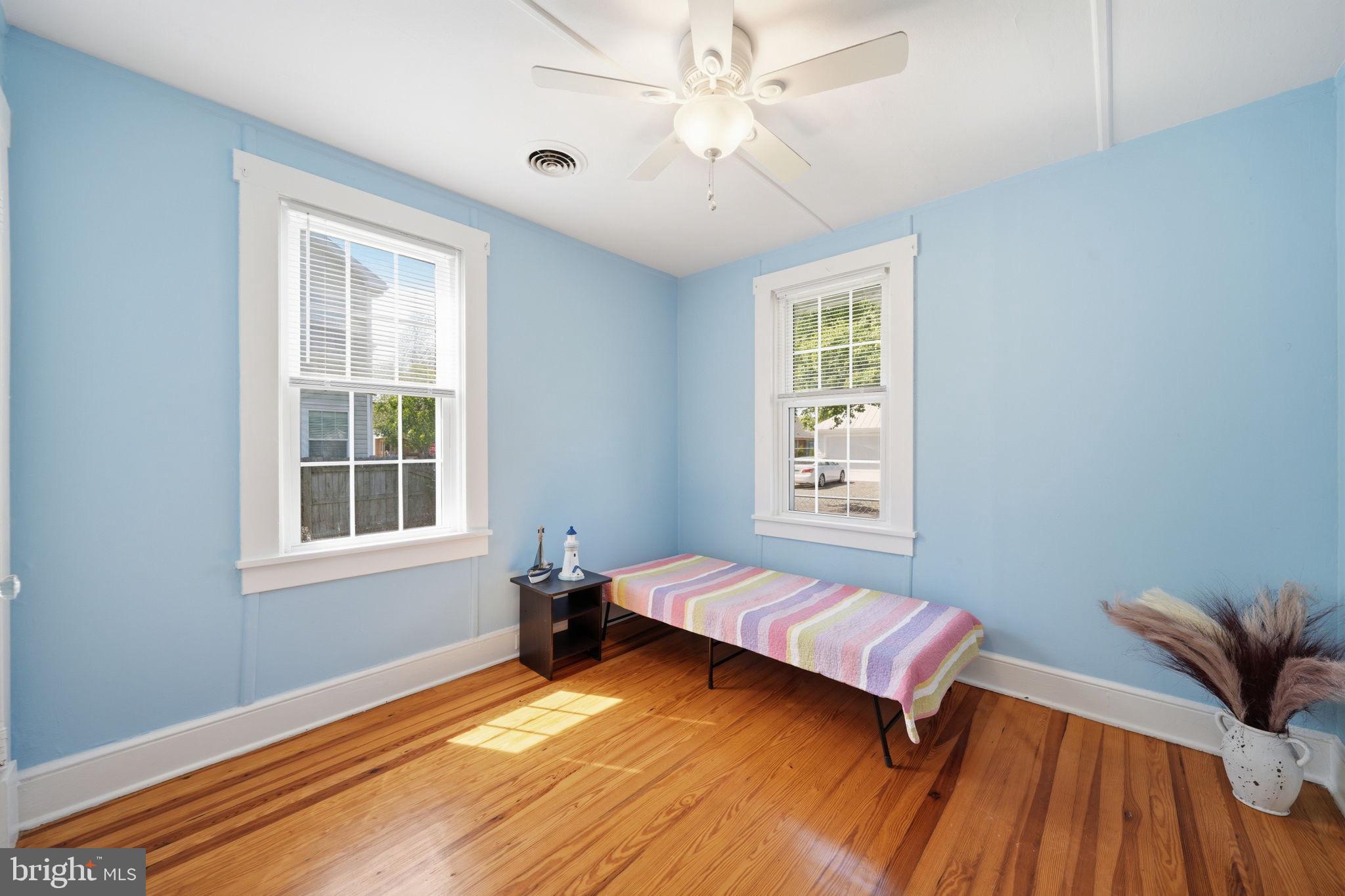 312 Vernon Street Colonial Beach, VA 22443 - Photo 24 of 45 a bedroom with a bed and wooden floor