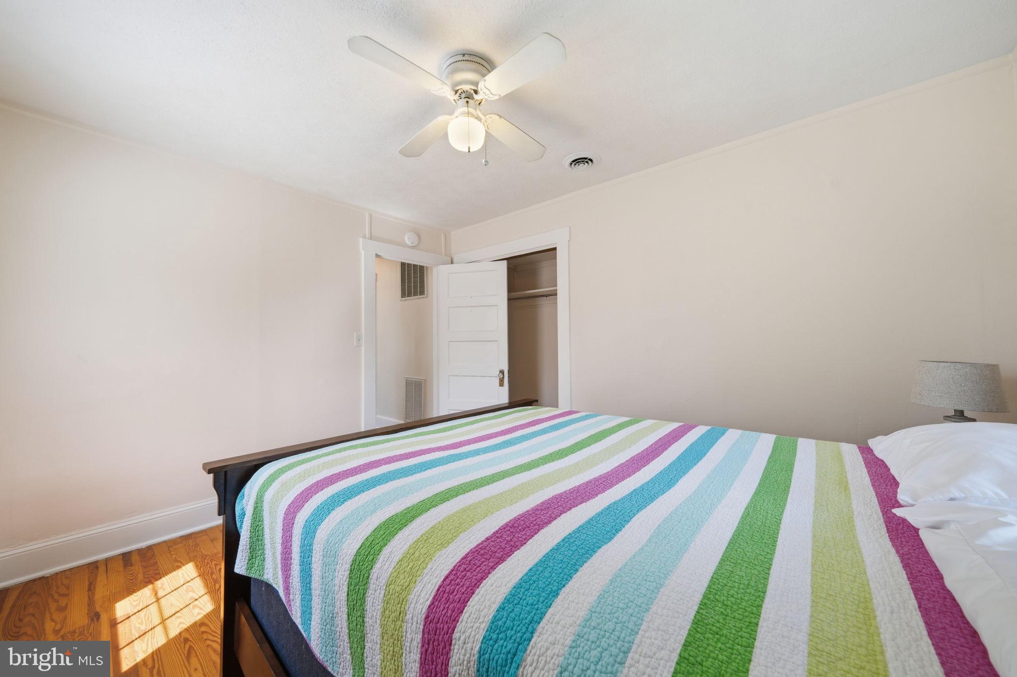 312 Vernon Street Colonial Beach, VA 22443 - Photo 27 of 45 a bedroom with a bed and a chandelier