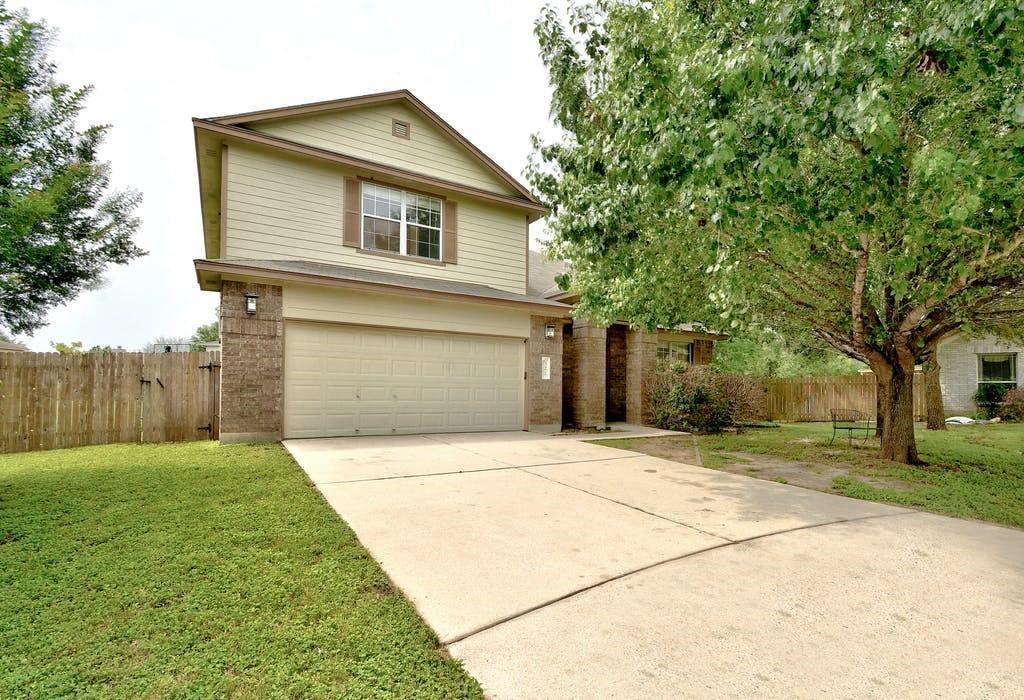 321 Lori Circle Bastrop, TX 78602 - Photo 1 of 1 a front view of a house with a yard and garage