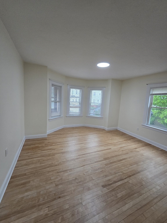 38 Fox Street, Unit 2 Worcester, MA 01604 - Photo 14 of 21 a view of empty room with window and wooden floor