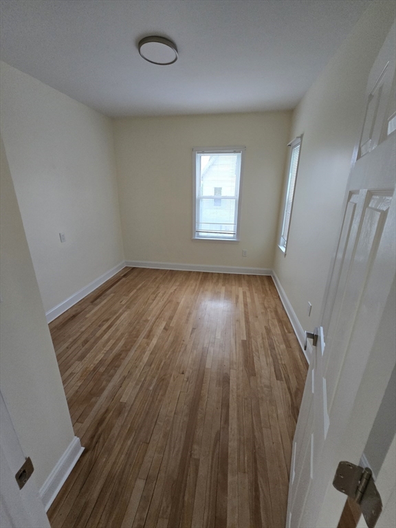 38 Fox Street, Unit 2 Worcester, MA 01604 - Photo 17 of 21 an empty room with wooden floor and windows