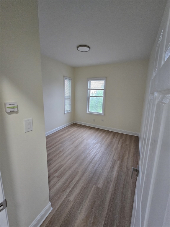 38 Fox Street, Unit 2 Worcester, MA 01604 - Photo 18 of 21 a view of an empty room with wooden floor and a window