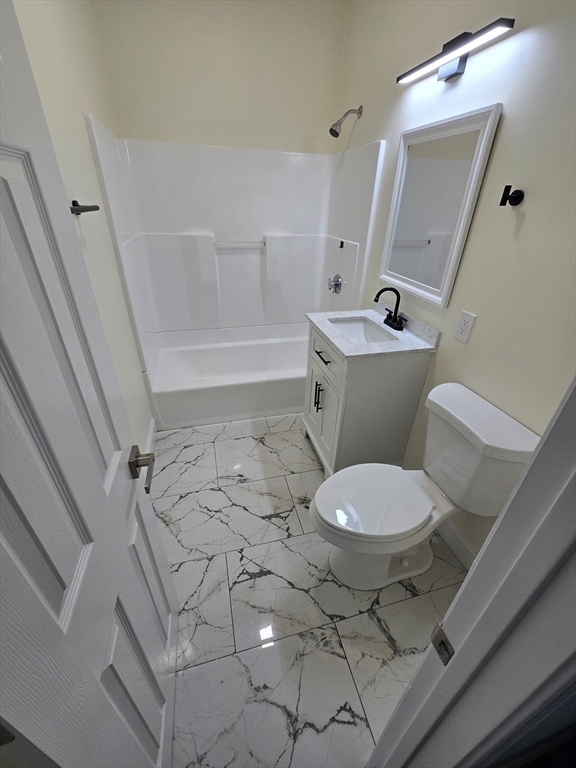 38 Fox Street, Unit 2 Worcester, MA 01604 - Photo 21 of 21 a bathroom with a sink a toilet a mirror and shower