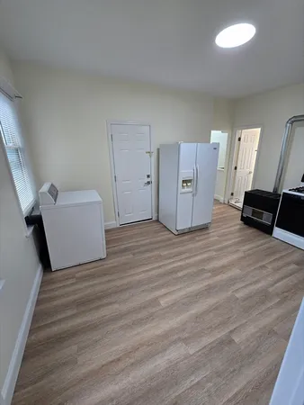 a view of a room with wooden floor and stairs