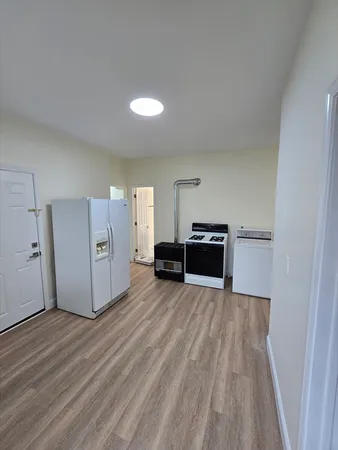 a view of a kitchen with wooden floor