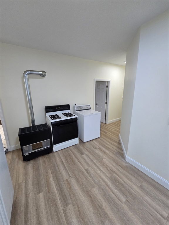 38 Fox Street, Unit 2 Worcester, MA 01604 - Photo 6 of 21 a living room with a couch and a wooden floor