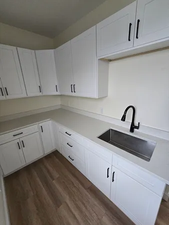 a view of white cabinets and sink