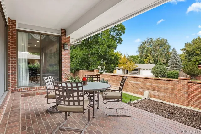 a view of a chairs and table in patio