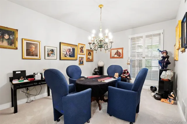 a living room with furniture a chandelier and a window