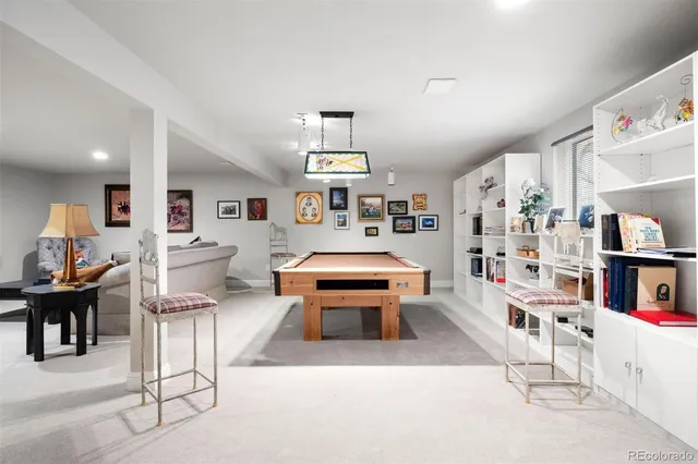 a living room with furniture and a book shelf