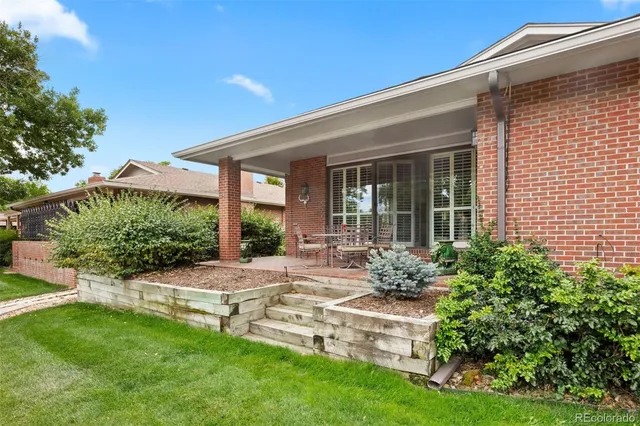 a view of a house with patio and garden