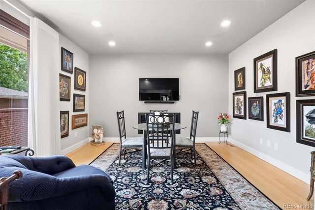 a living room with furniture a rug and a flat screen tv