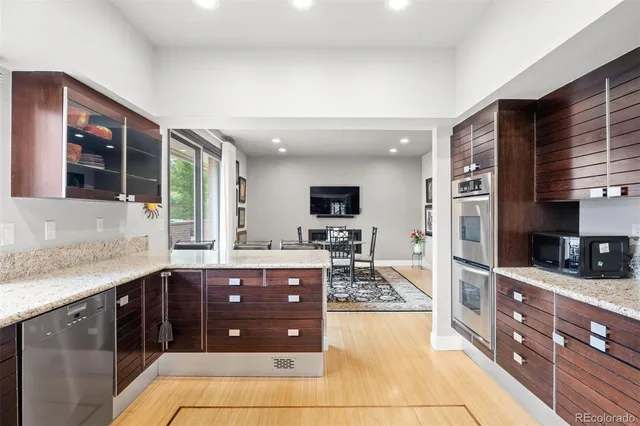 a kitchen with stainless steel appliances granite countertop a sink and cabinets