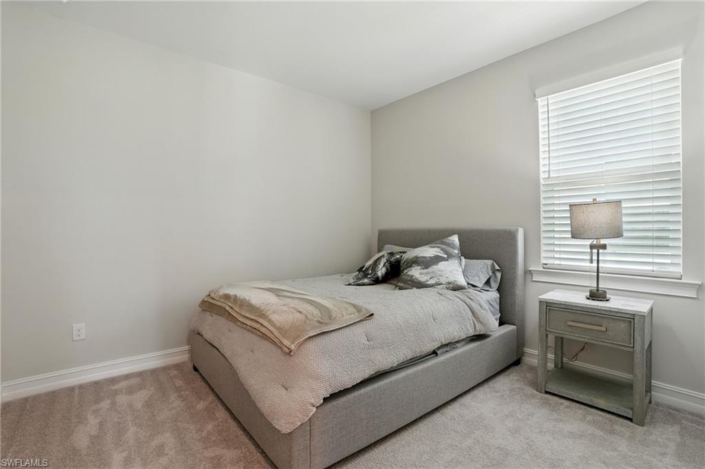 28165 Captiva Shell Loop Bonita Springs, FL 34135 - Photo 24 of 38 a bed sitting in a bedroom next to a window