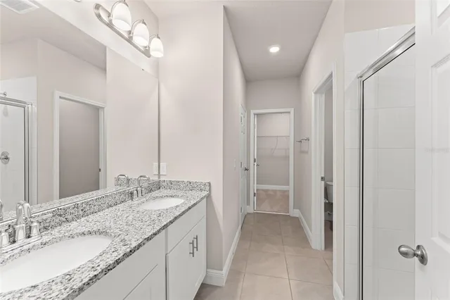 a front view of a house with a garden and trees