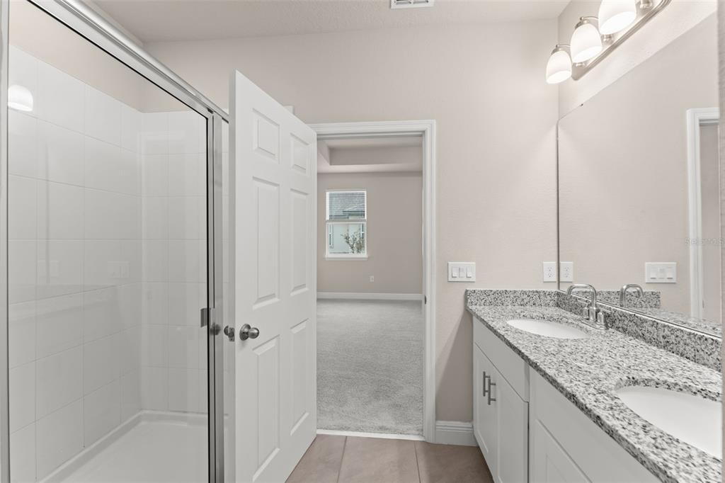 2224 Shadowland Loop Winter Park, FL 32792 - Photo 28 of 42 a bathroom with a granite countertop sink mirror and double