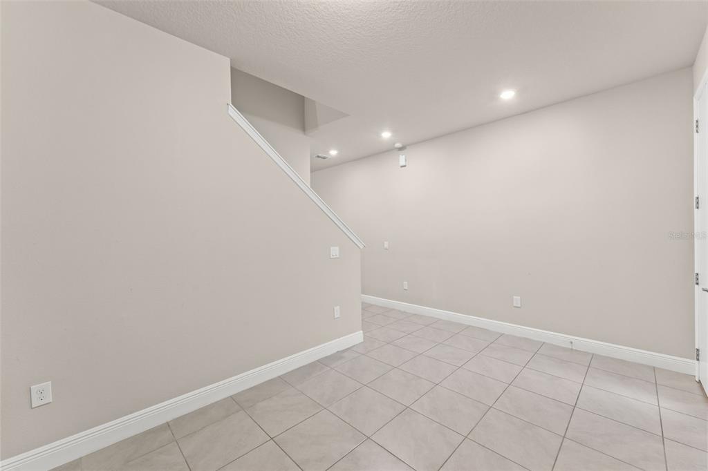 2224 Shadowland Loop Winter Park, FL 32792 - Photo 4 of 42 an empty room with white walls and tiles