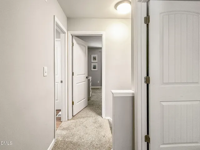 a view of a bathroom with a glass door and mirror