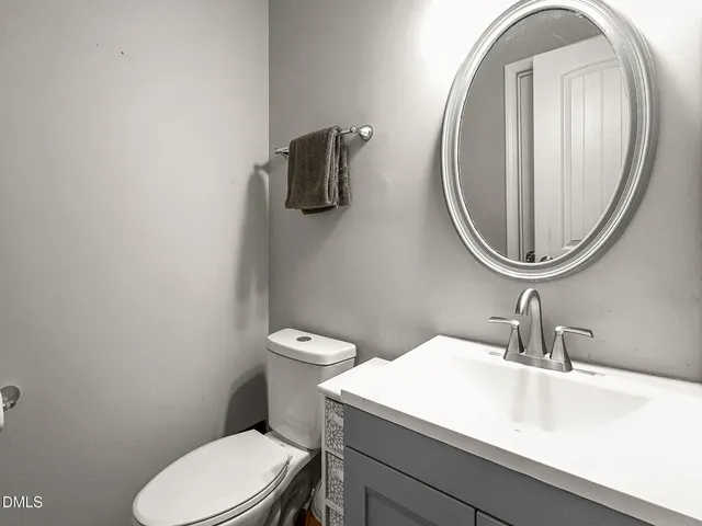 a bathroom with a sink a mirror and a toilet