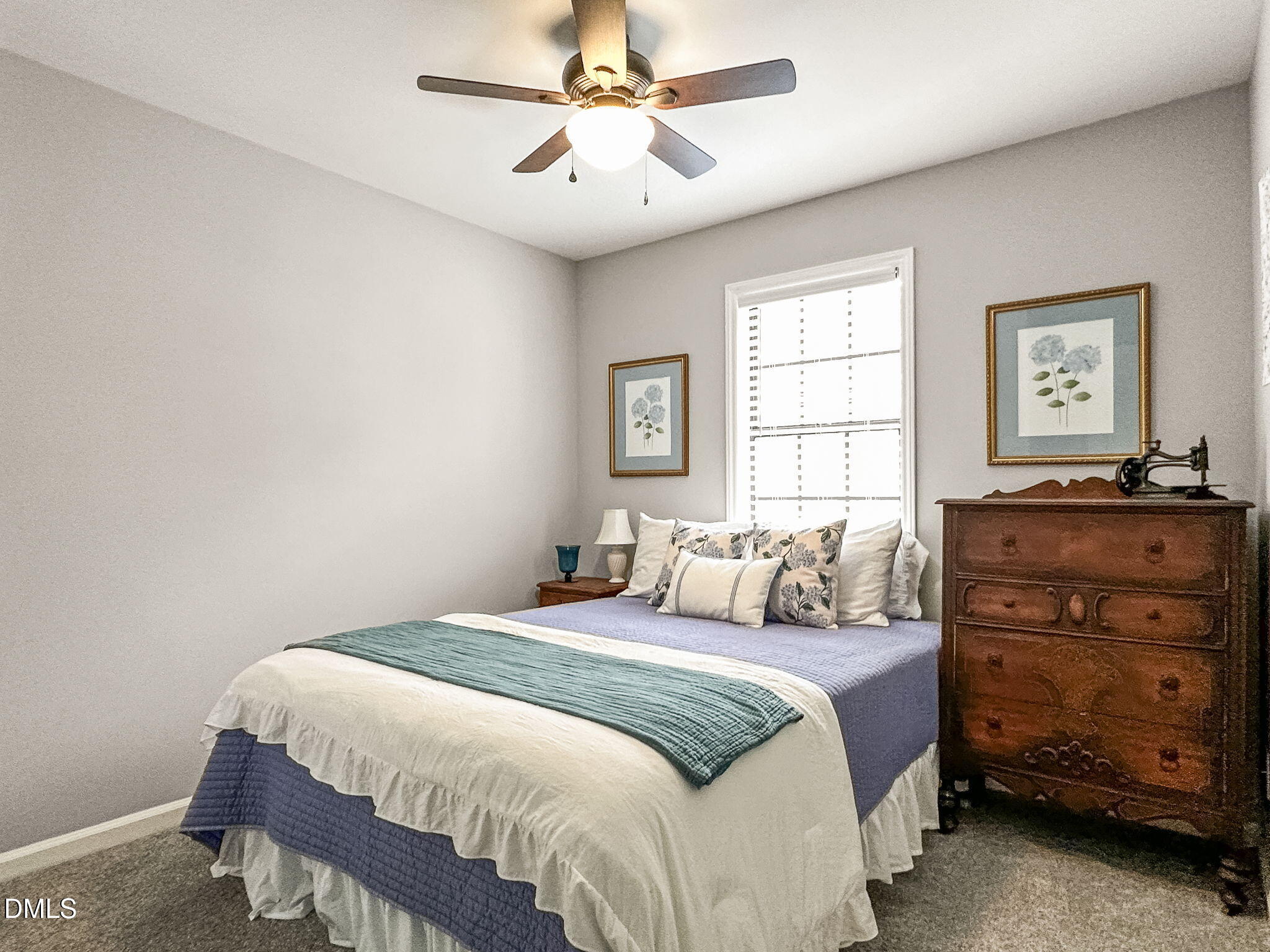 1019 Parkthrough Street Cary, NC 27511 - Photo 19 of 23 a bedroom with a bed and a chandelier