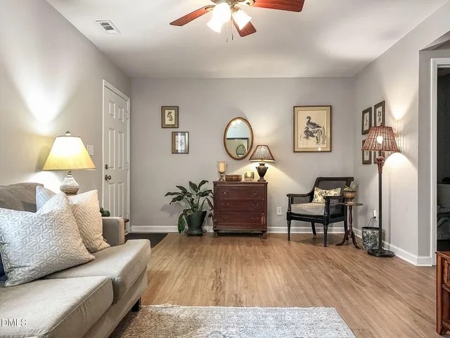 a living room with furniture and a lamp
