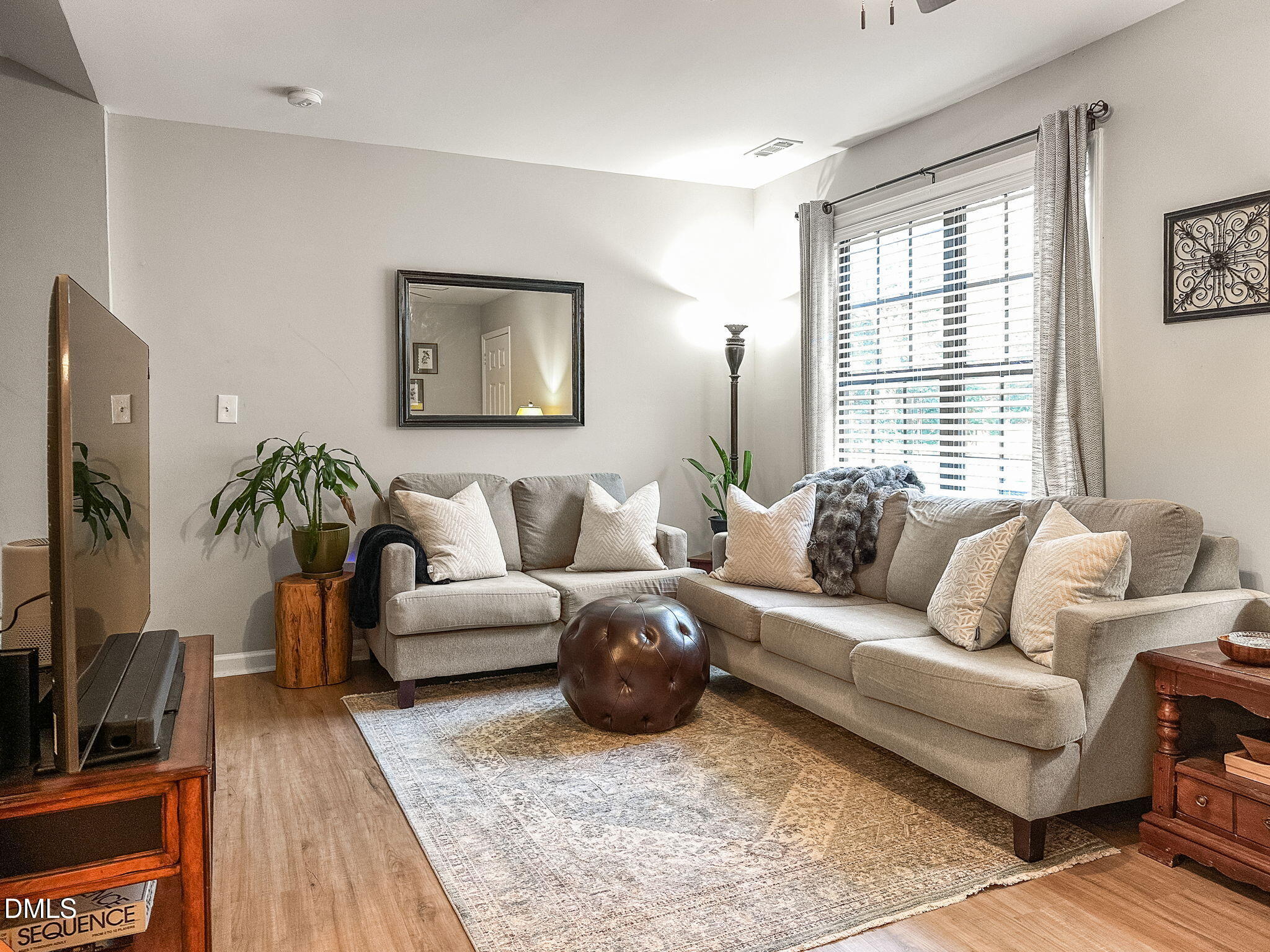1019 Parkthrough Street Cary, NC 27511 - Photo 5 of 23 a living room with furniture a flat screen tv and a window