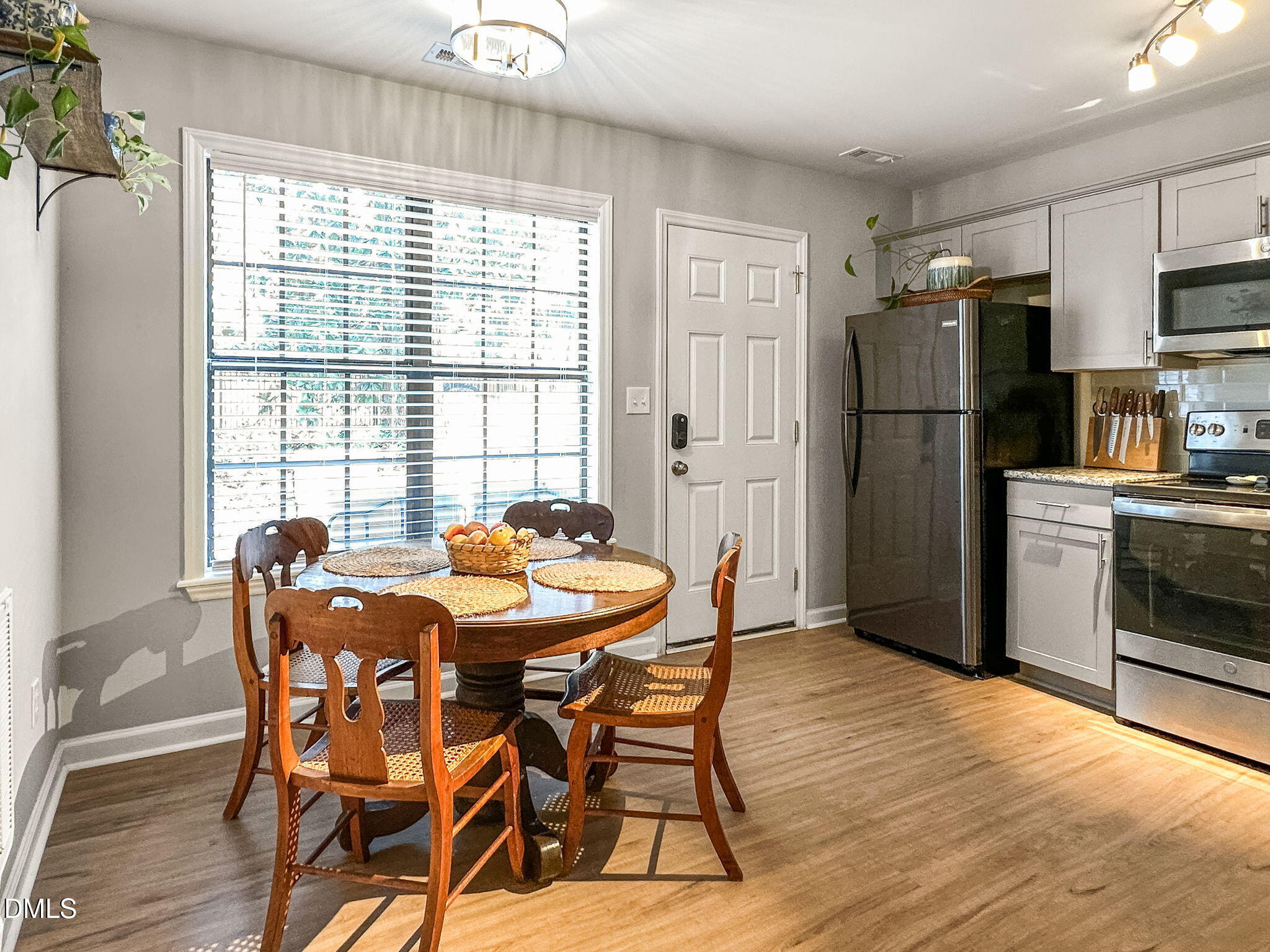 1019 Parkthrough Street Cary, NC 27511 - Photo 10 of 23 a dining room with furniture a window and stainless steel appliances